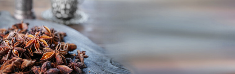 Anise seeds on a wooden board close-up. Banner, copy of the space