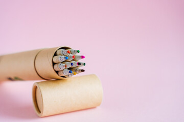 A set of colored pencils on a pink background. Draw with bright colored pencils. Pencils made of natural wood. Drawing and fantasizing