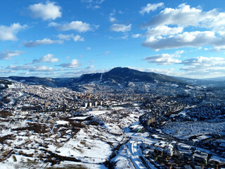 An aerial shot of the cityscape view of Sarajevo covered with the snow in Bosnia and Herzegovina