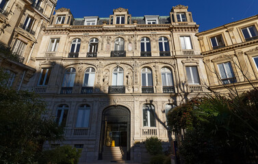 Naklejka premium The facade of traditional French house with typical balconies and windows. Paris.