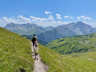 Father and his sons hiking in the Austrian Alps. Lech, Arlberg, Austria.