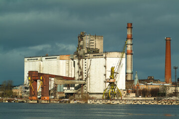 Fototapeta na wymiar Industrial buildings in the Riga cargo port in winter
