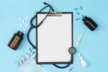 Fototapeta na wymiar A tablet with a blank page on a blue background. Medical diagnosis or a mock-up of a doctor's prescription.