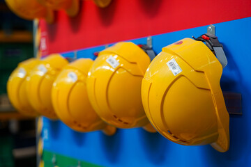 Yellow Helmets Hanging at the Factory Close Up
