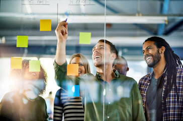 When productivity is a group activity. Shot of colleagues having a brainstorming session with sticky notes at work.