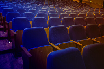 auditorium without people with blue chairs