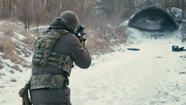 The soldier is shooting at targets on the range. 4k slow motion