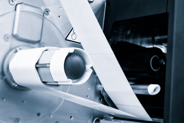 Fragment of the conveyor of sticking labeling machine. Abstract industrial background.