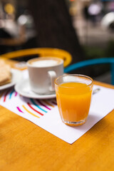 orange juice with coffee and ham and toasted cheese sandwiches