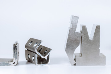 Equipment for bending sheet metal on a CNC bending machine on a white background. Matrix and curved...