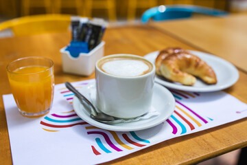 coffee, orange juice, croissants and sweeteners