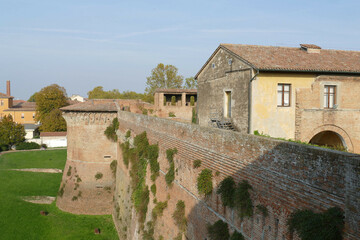 Fototapeta na wymiar panorama of the walls, of the towers and of the green lawn from the raised patrol walkways of Sforza Castle in Imola
