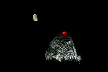 Radio telescope antenna with the rising moon