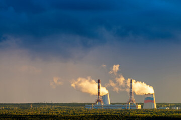 Cooling tower coolers against the background of a stormy sky