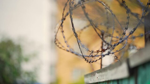 Barbed wire. Prison fence. View at the barb wall of the crime area or closed military camp. Security, Protection and Exclusion.