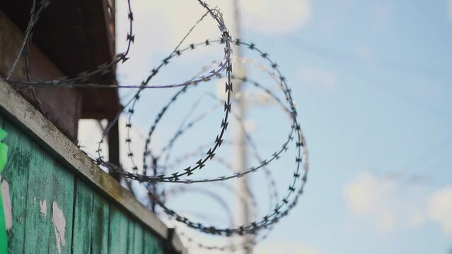 Barbed wire. Prison fence. View at the barb wall of the crime area or closed military camp. Security, Protection and Exclusion.