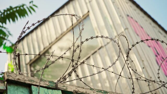 Barbed wire. Prison fence. View at the barb wall of the crime area or closed military camp. Security, Protection and Exclusion.