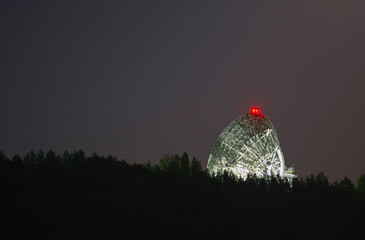Radio telescope antenna against the background of the night starry sky
