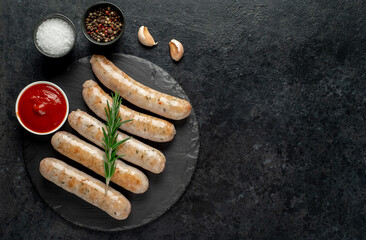 grilled sausages on stone background with copy space for your text