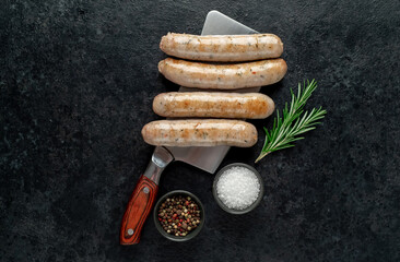 grilled sausages on stone background