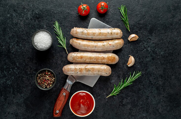 grilled sausages on stone background