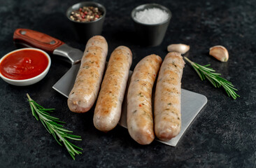 grilled sausages on stone background