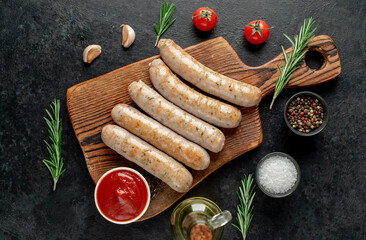 grilled sausages on stone background - obrazy, fototapety, plakaty