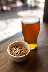 craft beer next to salted peanuts