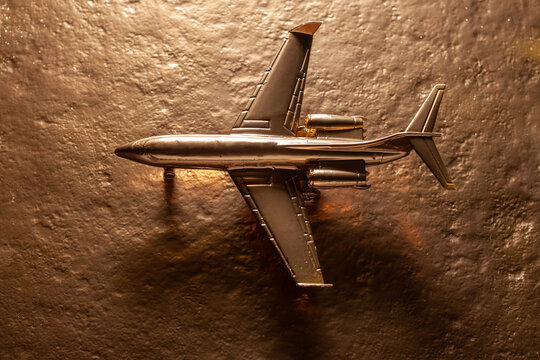 golden toy airplane on gold background