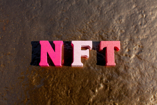 nft letters on golden background