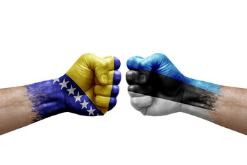 Two hands punch to each others on white background. Country flags painted fists, conflict crisis concept between bosnia and estonia