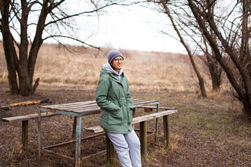 Outdoor portrait of young smiling  woman, wearing basics. Nature concept.