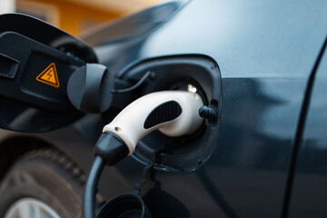 Home charging station for EV car. Close-up view of plug-in.