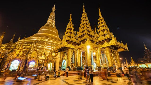 Time lapse view of historic landmark Shwedagon Pagoda Buddhist temple at night in Yangon, Myanmar (Burma).