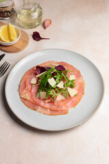 Carpaccio with mixed salad and parmesan. Close-up, with ingredients for cooking. Vertical