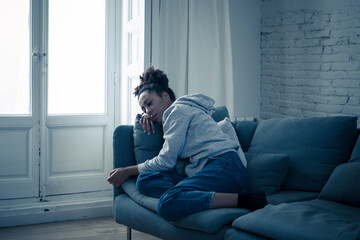 Young african american woman suffering from depression, anxiety and mental health illness