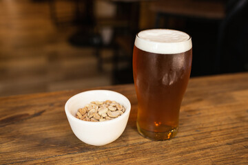 craft beer next to salted peanuts