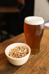 craft beer next to salted peanuts
