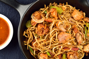 closeup of chicken noodles in pan