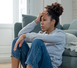 Sad black woman suffering from depression symptoms feeling distressed alone at home