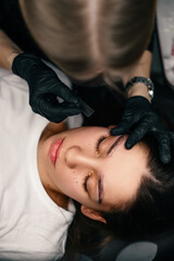 Beauty masters hands do permanent eyebrow makeup. Minimal trauma to skin. Eyebrow microblading is...