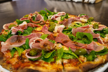 raw ham pizza and rucula