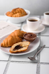 coffee and croissants, chocolate cream, french press on the table, morning breakfast 