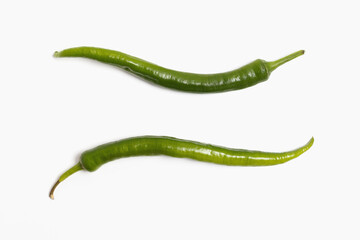 Two green chili peppers isolated on white background. top veiw, flat lay