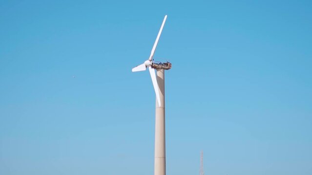 Close up shot of Windmill in background of clear blue sky, windmill for electric power production. At Mandvi beach, Kutch, Gujarat, India