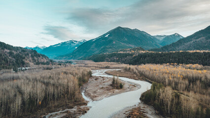 Arial / drone shot of Chilliwack river / Vedder river with mountains, forest, trees and clouds in the background, located in Chilliwack BC Canada near Vancouver, Abbotsford and Hope.