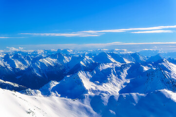 Austrian Alps covered with fresh snow during sunny winter day.