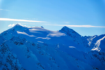 Austrian Alps covered with fresh snow during sunny winter day.
