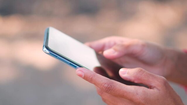 Close up shot of female hands using mobile phone. Teenager girl using social media on smartphone. Texting message. Concept of social media addiction in teens