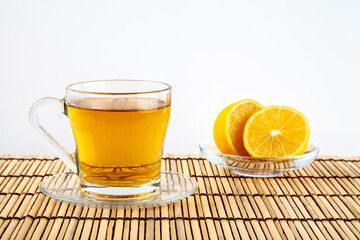 Green tea cup and lemon on wooden background